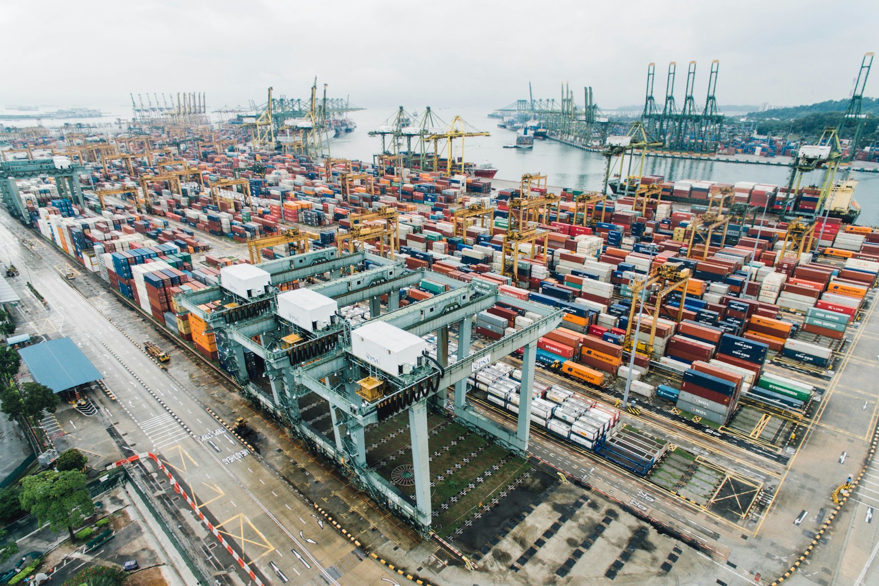 Aerial view of a major container terminal with gantry cranes and thousands of stacked containers